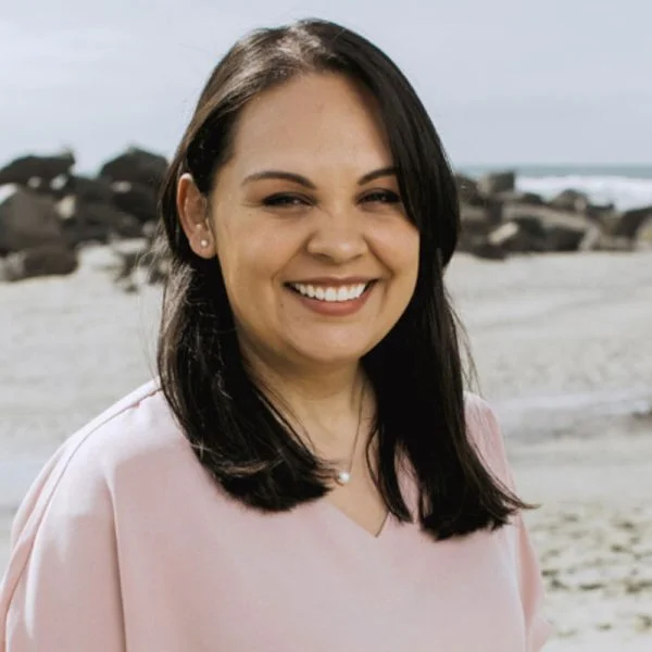 Angelica Quezada, LCSW, PMH-C, smiling on a beach