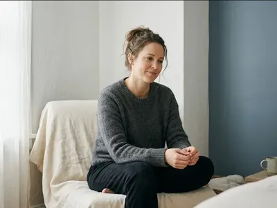 Two people in a kitchen, one quietly supporting the other, warm domestic light, representing the themes of "Talking to Your Partner About Career and Motherhood Struggles".